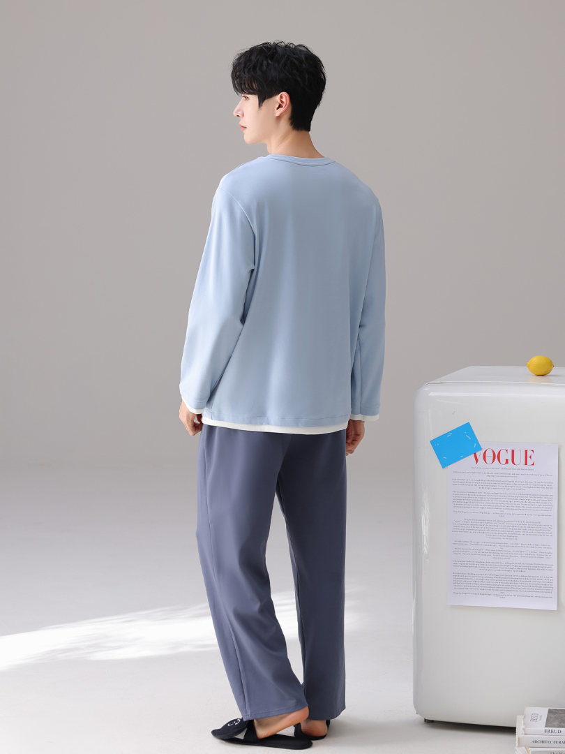 Model wearing a light blue loungewear set with long-sleeve top and wide-leg pants