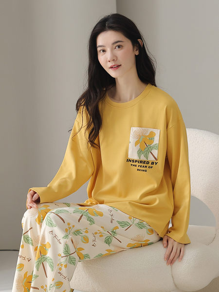 Woman wearing a yellow long-sleeve loungewear set with floral print pants
