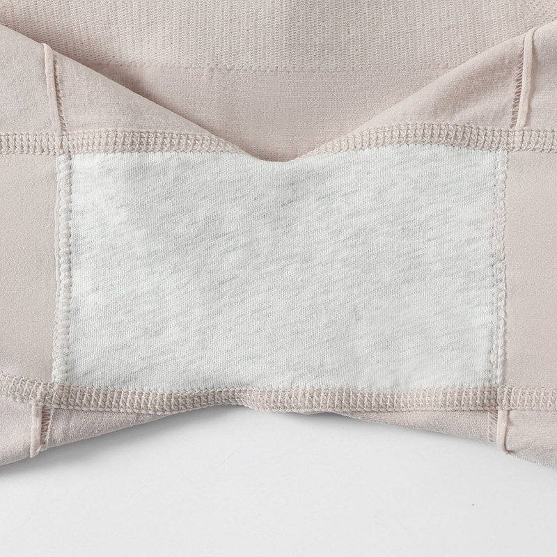 Close-up of a beige fabric garment with visible stitching and a white inner panel