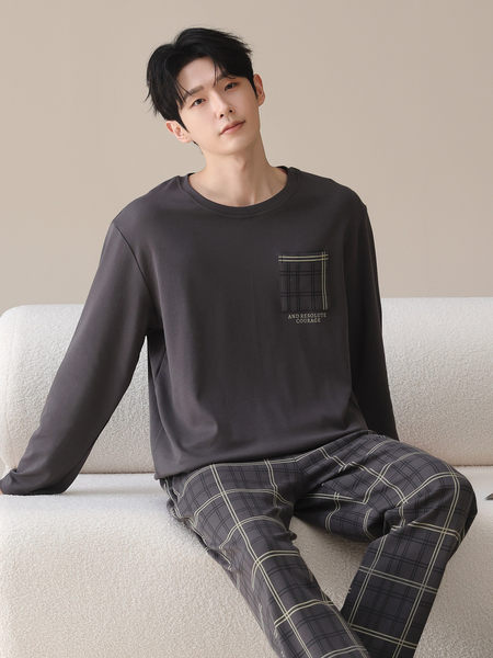 Model wearing a dark gray long-sleeve top with plaid lounge pants