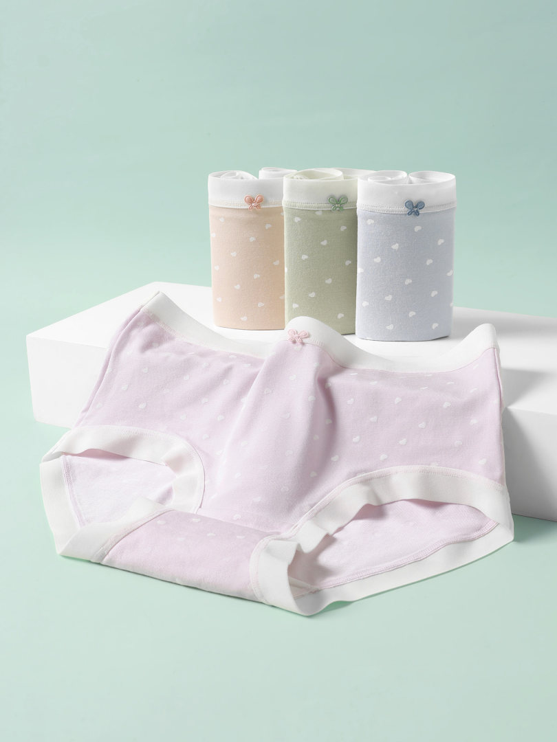 Pastel women's underwear briefs displayed on a studio background