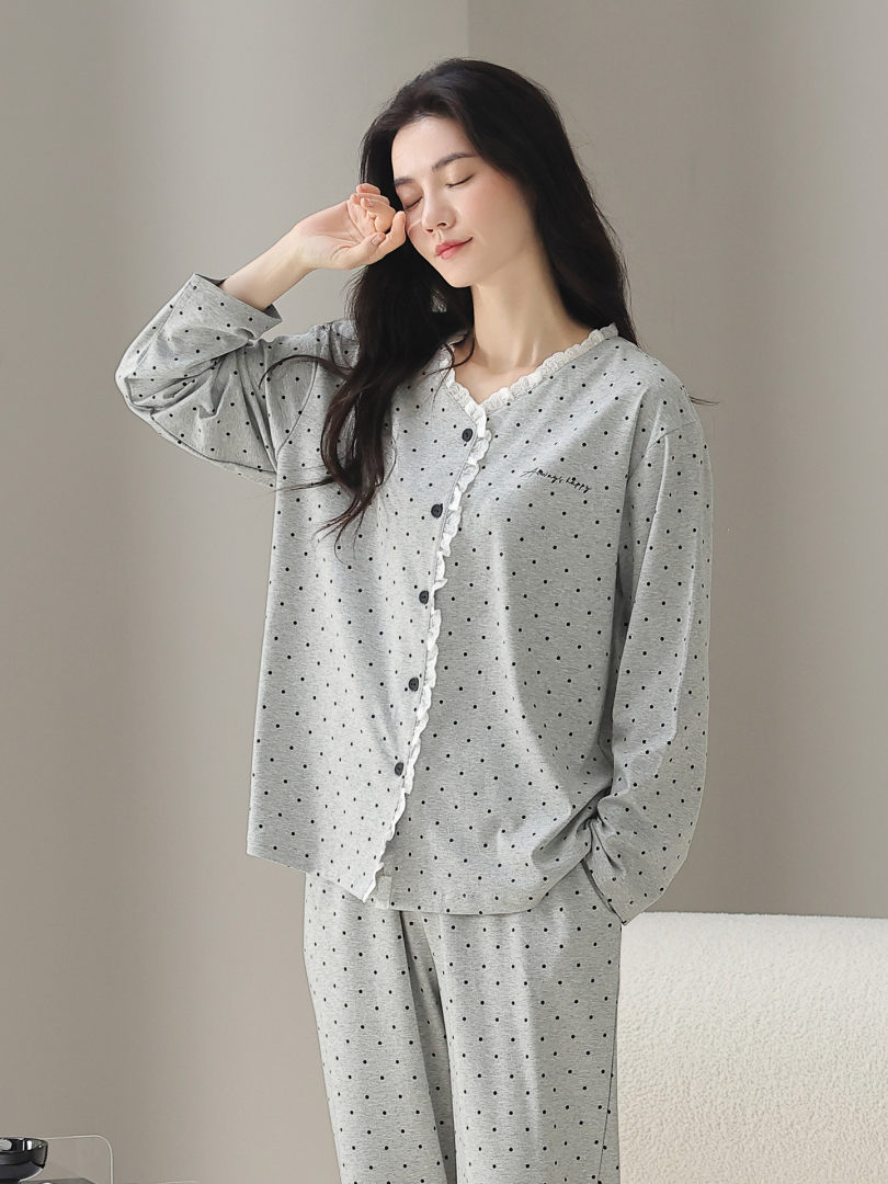 Model wearing a gray polka dot loungewear pajama set
