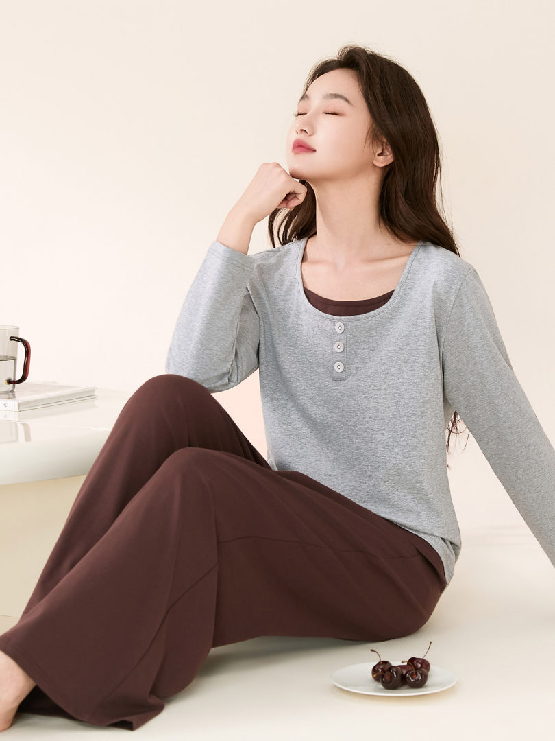 Model wearing a gray long-sleeve button-front top with brown wide-leg pants