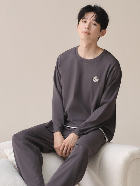 Man wearing a dark gray long-sleeve loungewear set with matching pants