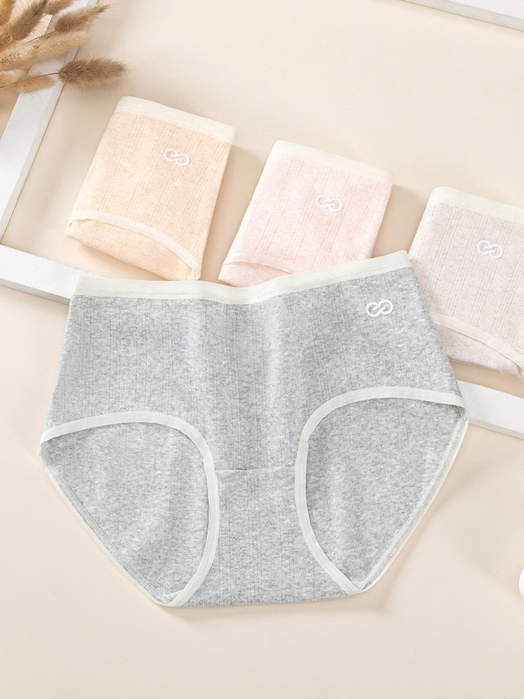 Set of pastel and gray women’s underwear briefs laid flat