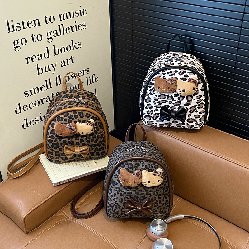 幼儿园儿童可爱猫咪公仔豹纹小书包2025韩版洋气手提蝴蝶结双肩包