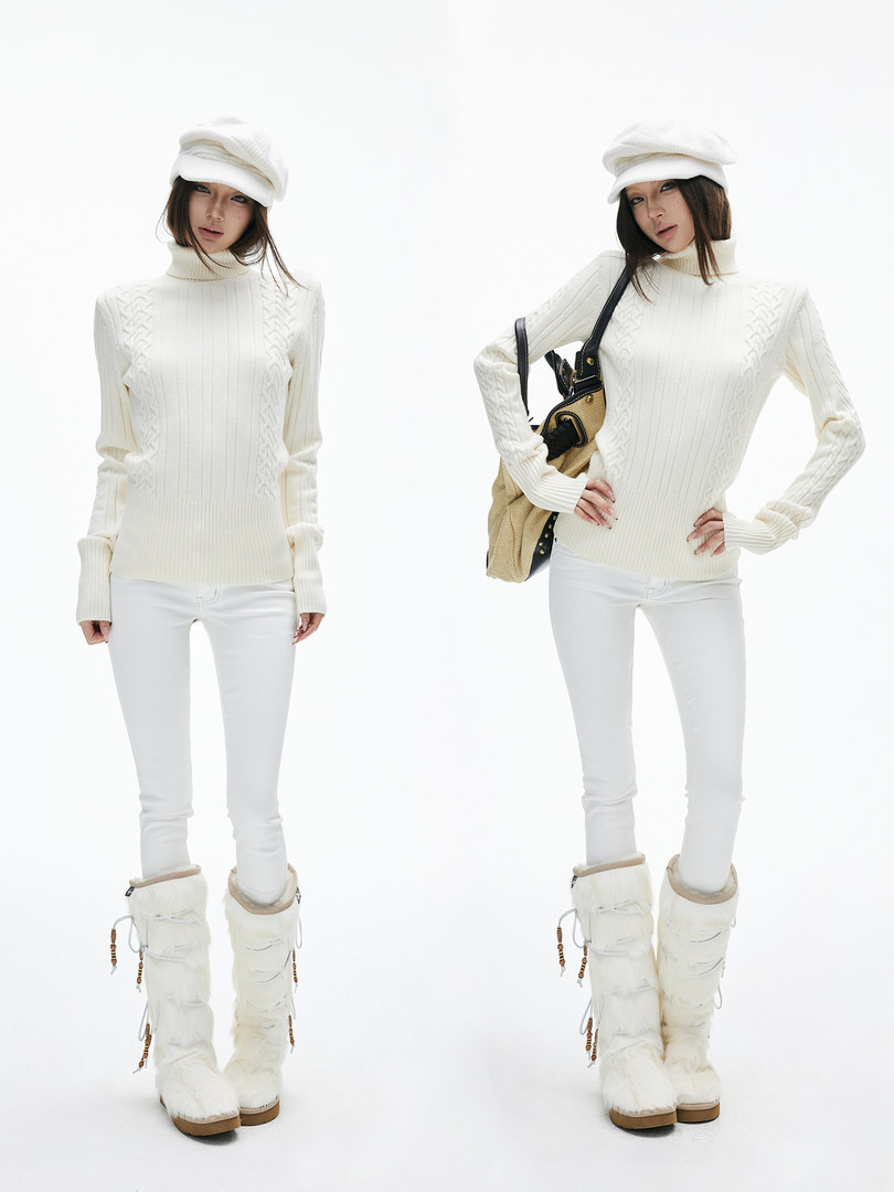 Model wearing a white knit turtleneck sweater with white pants and fur winter boots