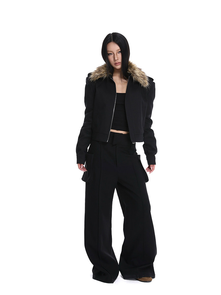 Model wearing a black cropped jacket with faux fur collar and wide-leg black pants