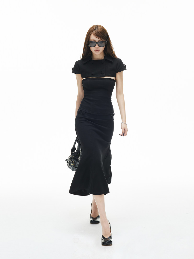 Black fitted two-piece outfit worn by a model on a white background