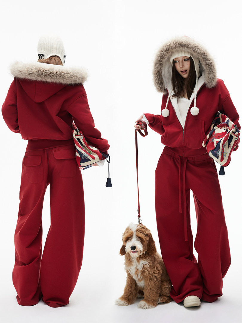 Model wearing a red fur-trim hooded winter outfit with wide-leg pants