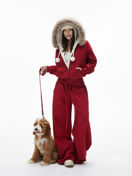 Red hooded tracksuit outfit with fur-trimmed hood worn by a model