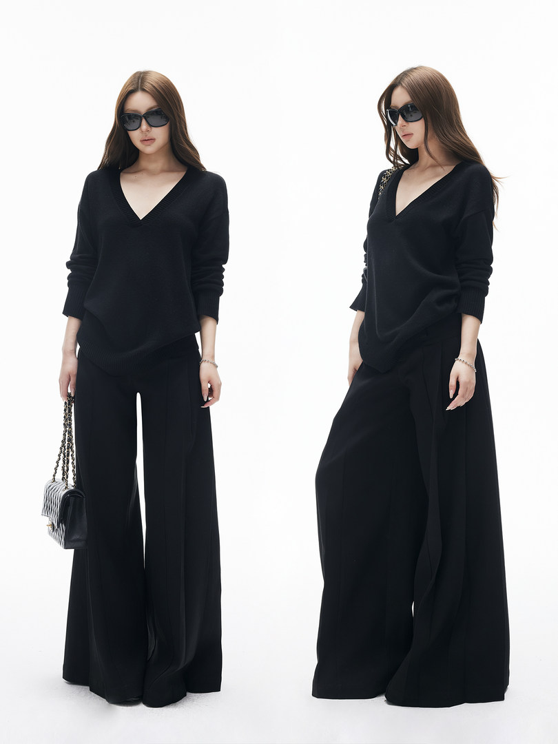 Black two-piece outfit with a V-neck sweater and wide-leg pants worn by a model