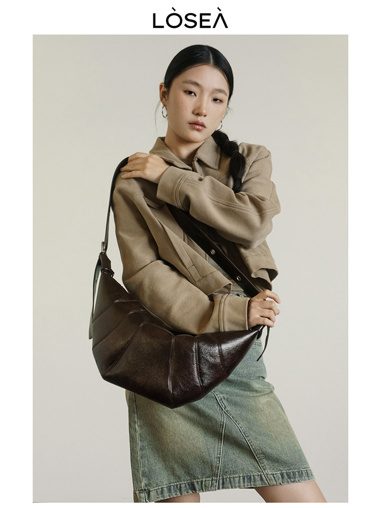 Model wearing a dark brown leather shoulder bag