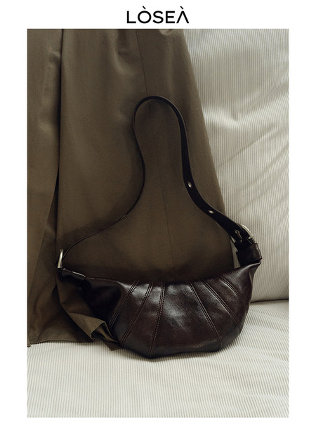 Dark brown leather shoulder bag displayed on a neutral background