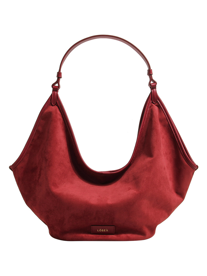 Red satin-like shoulder handbag on white background