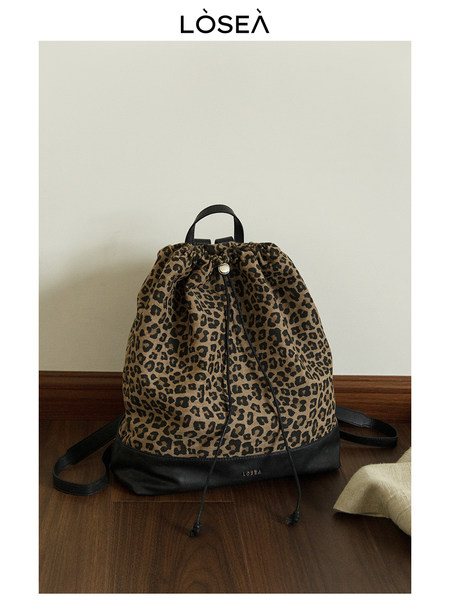 Leopard print drawstring backpack with black leather base