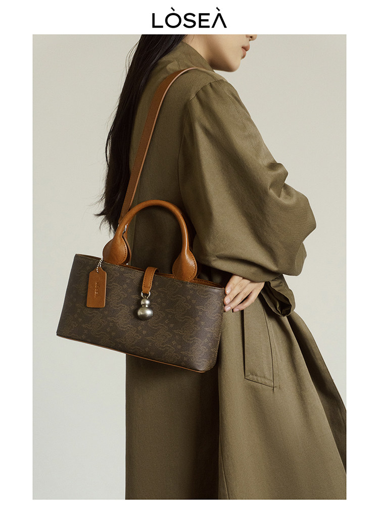 Brown monogram leather handbag worn by a model