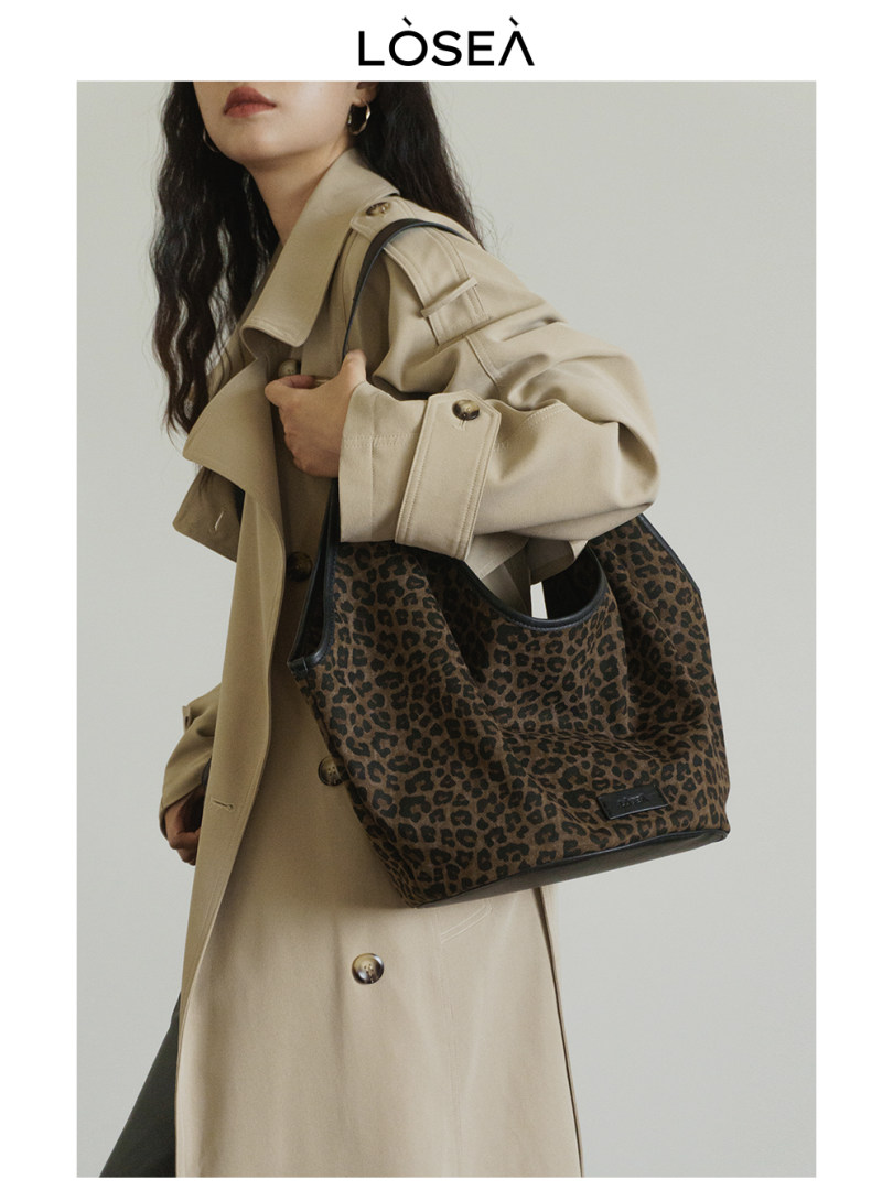 Leopard print tote bag worn by a model with a beige trench coat