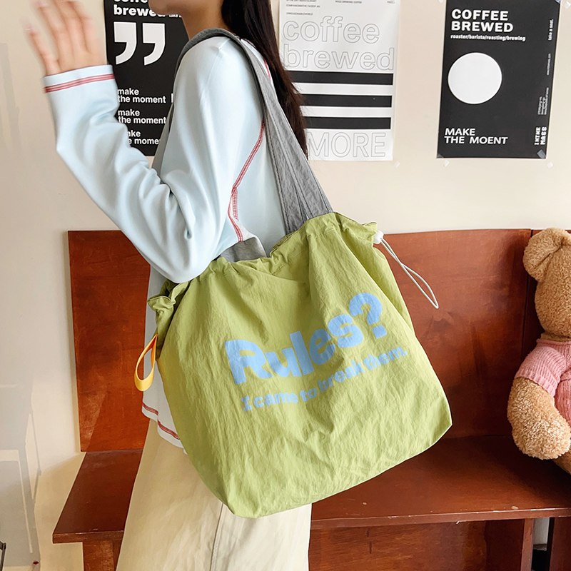 慵懒小众抽绳包包简约百搭大容量托特包学生书袋通勤单肩包购物袋