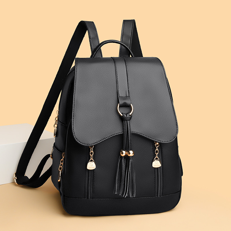 真皮中老年2026时尚黑色翻盖双肩包女通勤大容量流苏书包简约背包