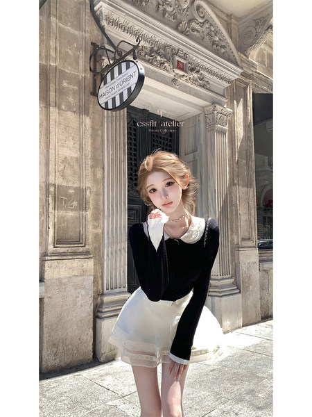 Woman wearing a black and white long-sleeve dress outdoors