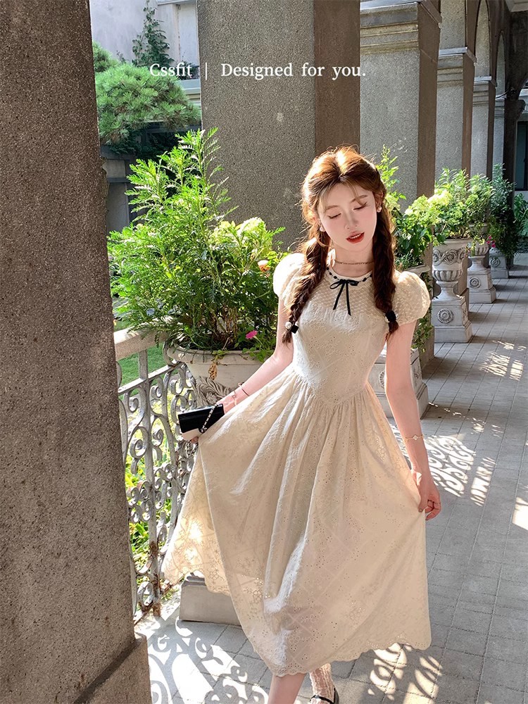 Cream lace puff-sleeve midi dress worn by a model outdoors