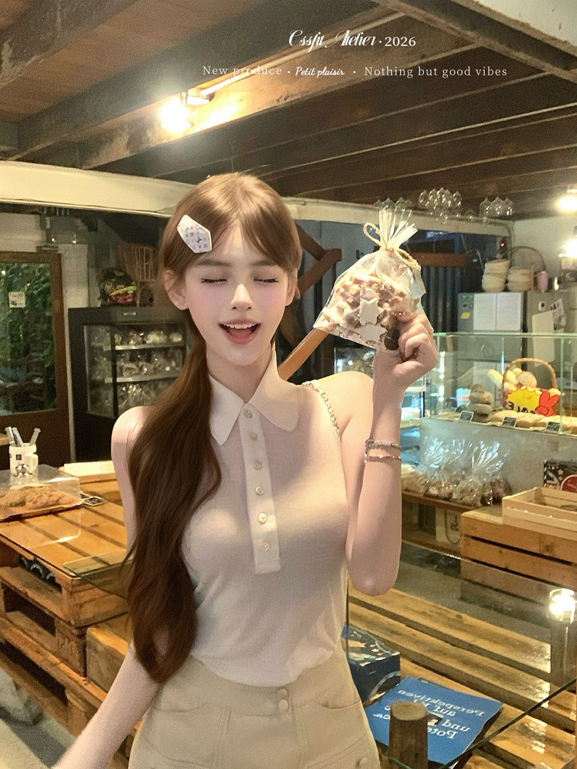 Woman wearing a sleeveless white collared top in a shop