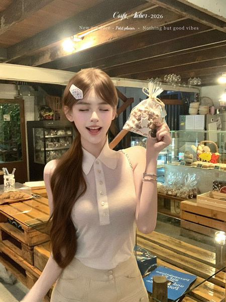 Woman wearing a sleeveless white collared top in a shop