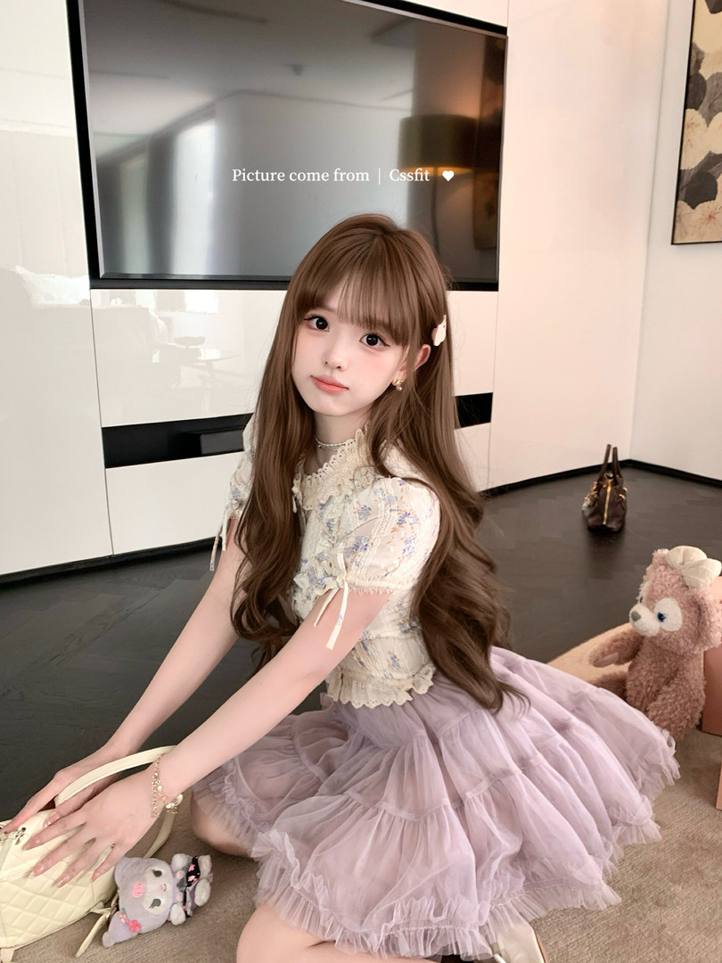 Young woman modeling a cute lace top and lavender tulle skirt outfit