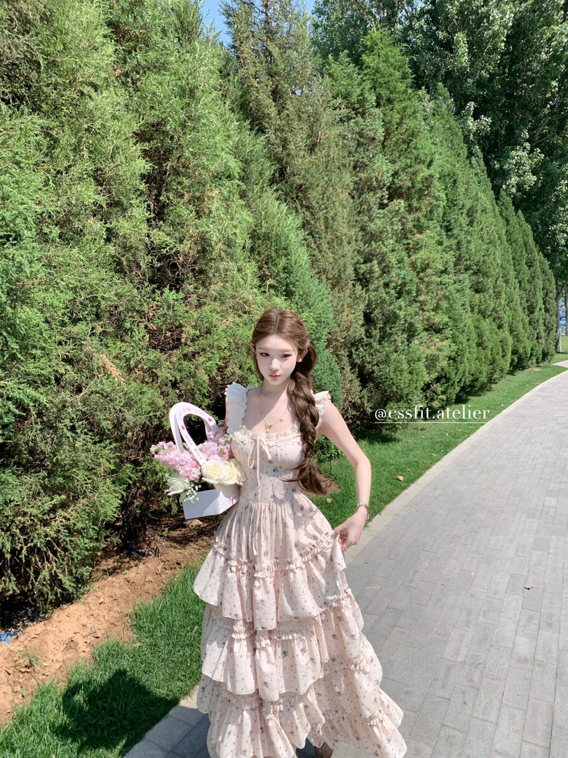 Woman wearing a light floral ruffled dress outdoors