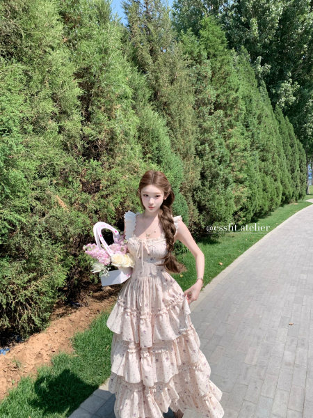 Woman wearing a light floral ruffled dress outdoors