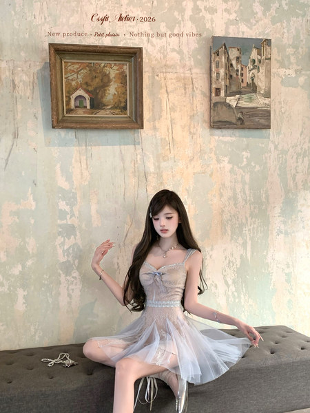 Model wearing a light blue sheer lace dress with tulle skirt