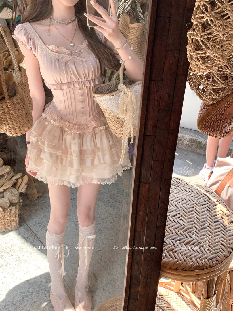 Light pink lace-trimmed dress worn by a model in a mirror selfie