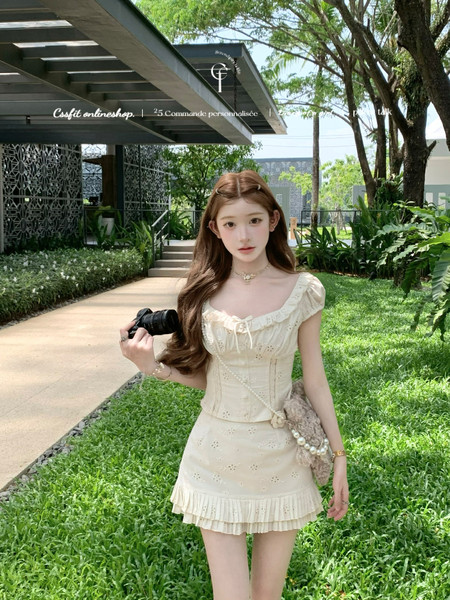 Woman wearing a cream ruffled mini dress outdoors