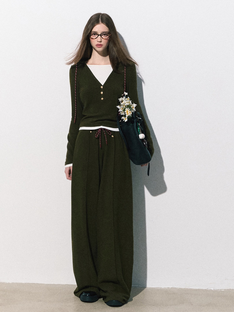 Model wearing a dark green matching knit top and wide-leg pants set
