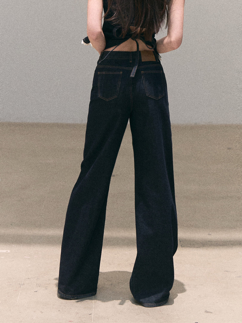 Model wearing black wide-leg jeans
