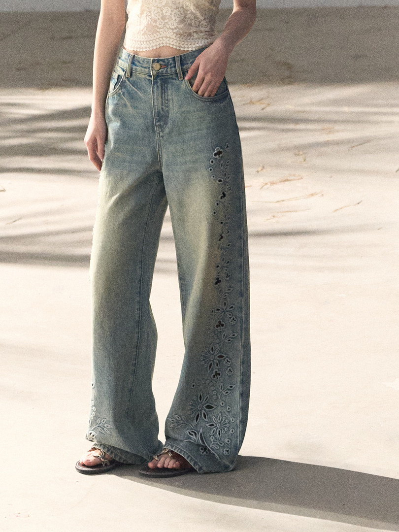 Wide-leg embroidered jeans worn by a model