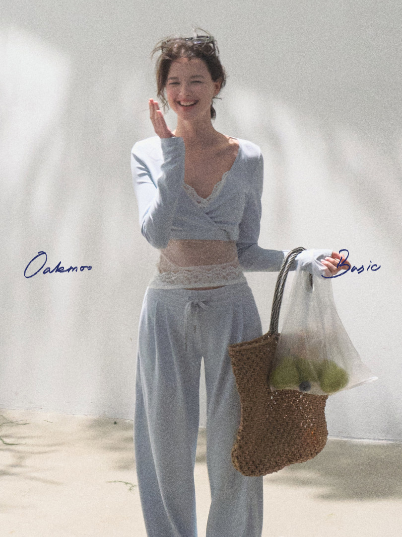 Woman modeling a light blue loungewear set with a crop top and wide-leg pants
