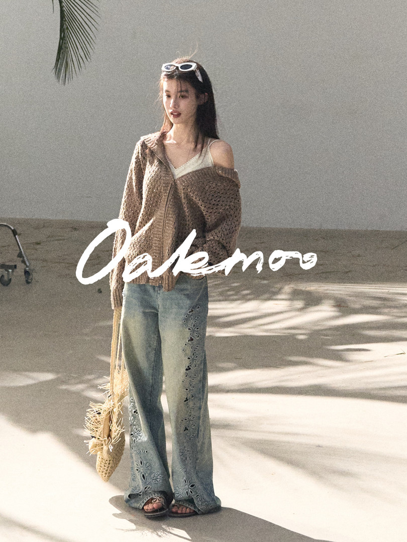 Fashion model wearing a brown knit cardigan and embroidered wide-leg jeans