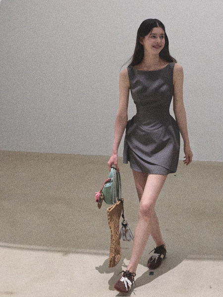 Model wearing a gray satin sleeveless mini dress