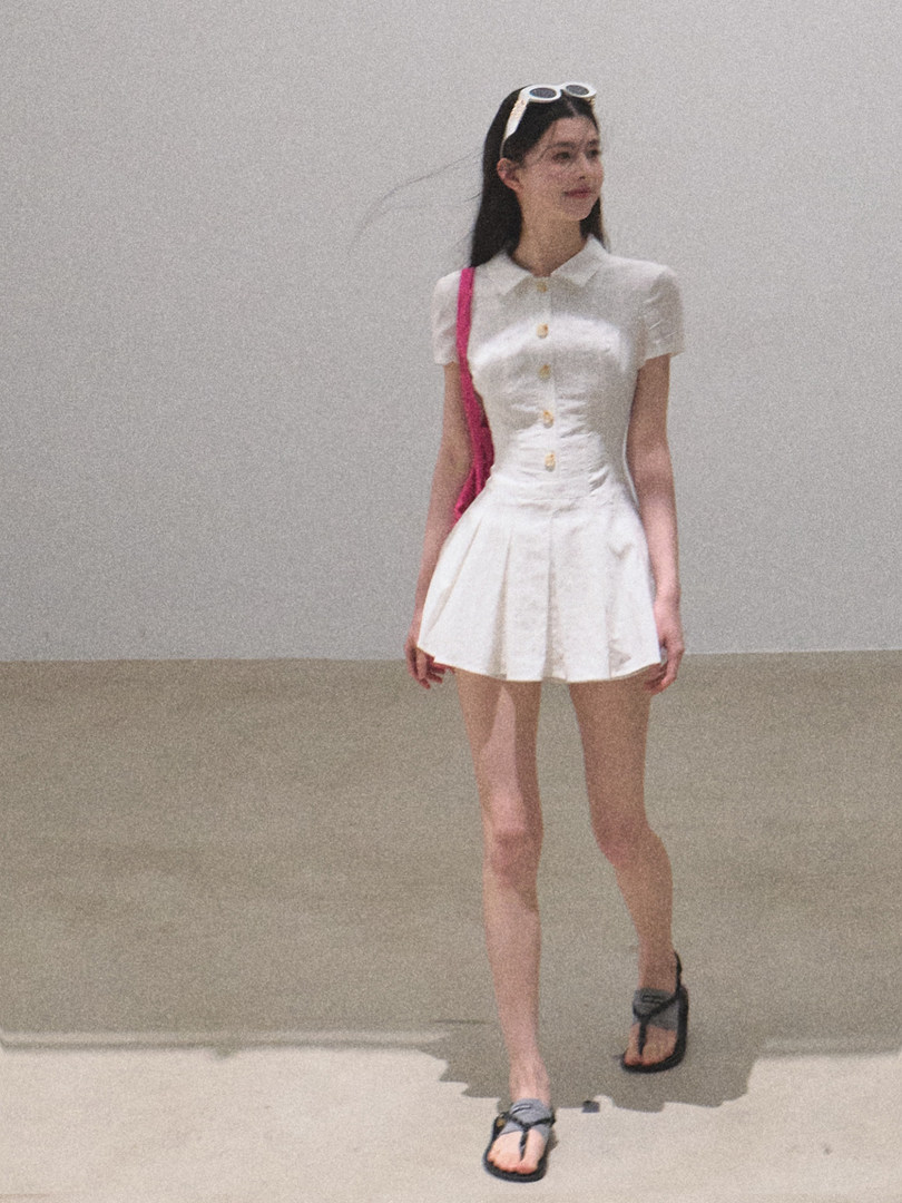 White short-sleeve button-front dress worn by a model