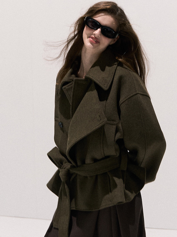 Dark olive belted coat worn by a model