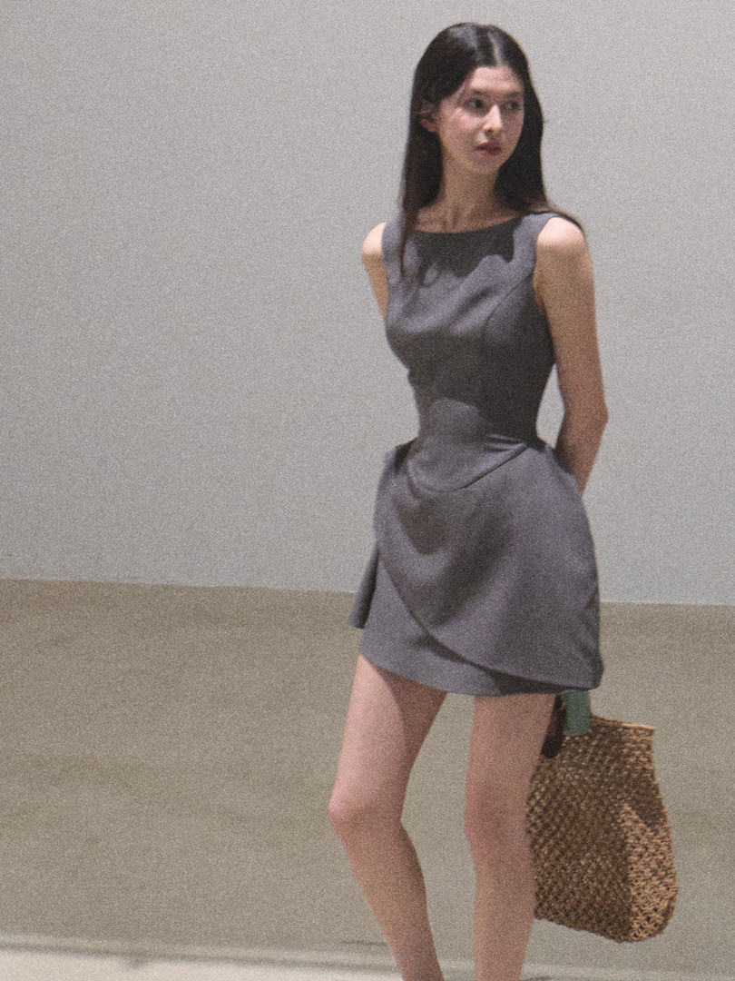 Gray sleeveless fitted mini dress worn by a model