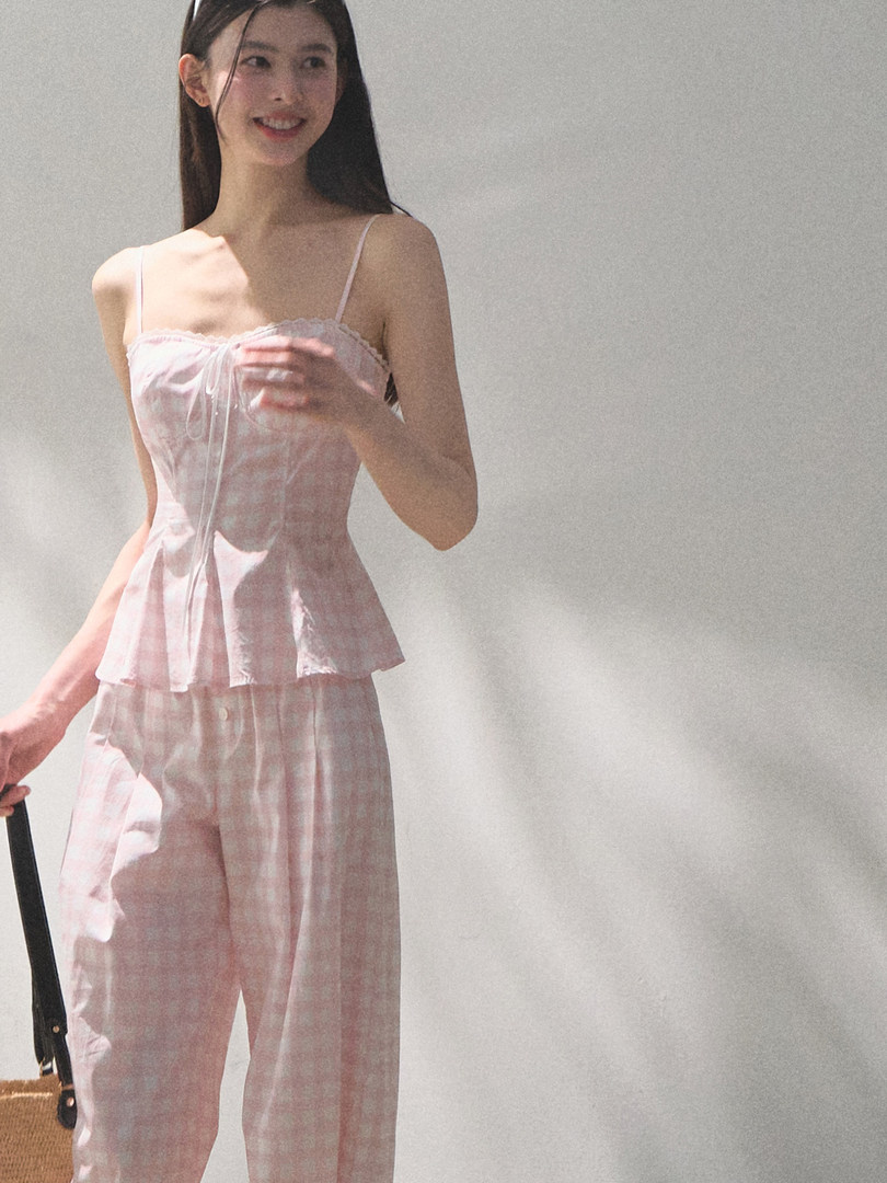 Model wearing a pink sleeveless loungewear set with matching pants