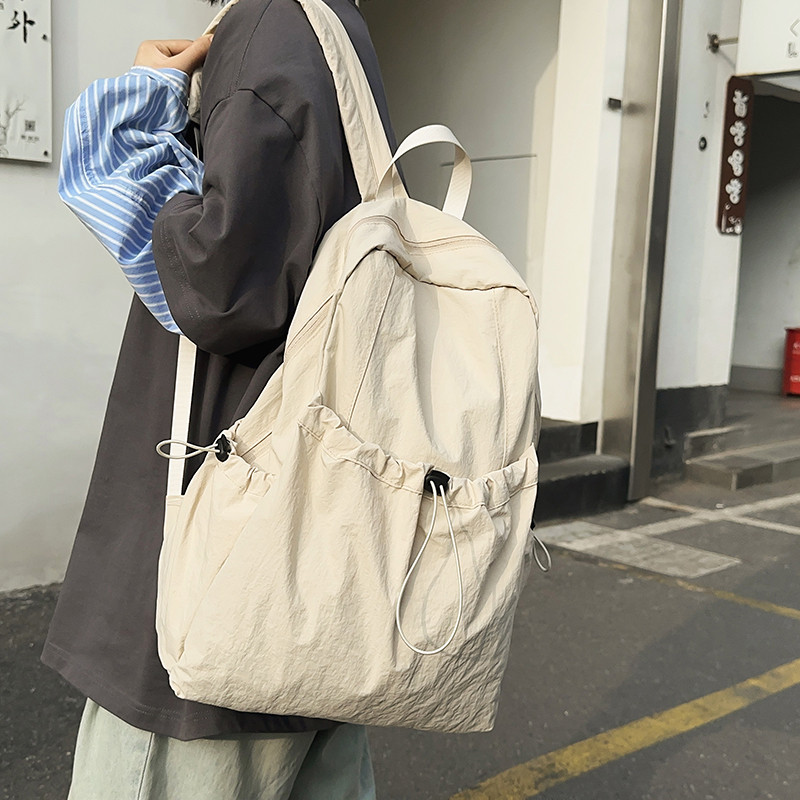 韩国新品2024街头运动休闲风纯色抽带水桶包搭扣双肩背包书包