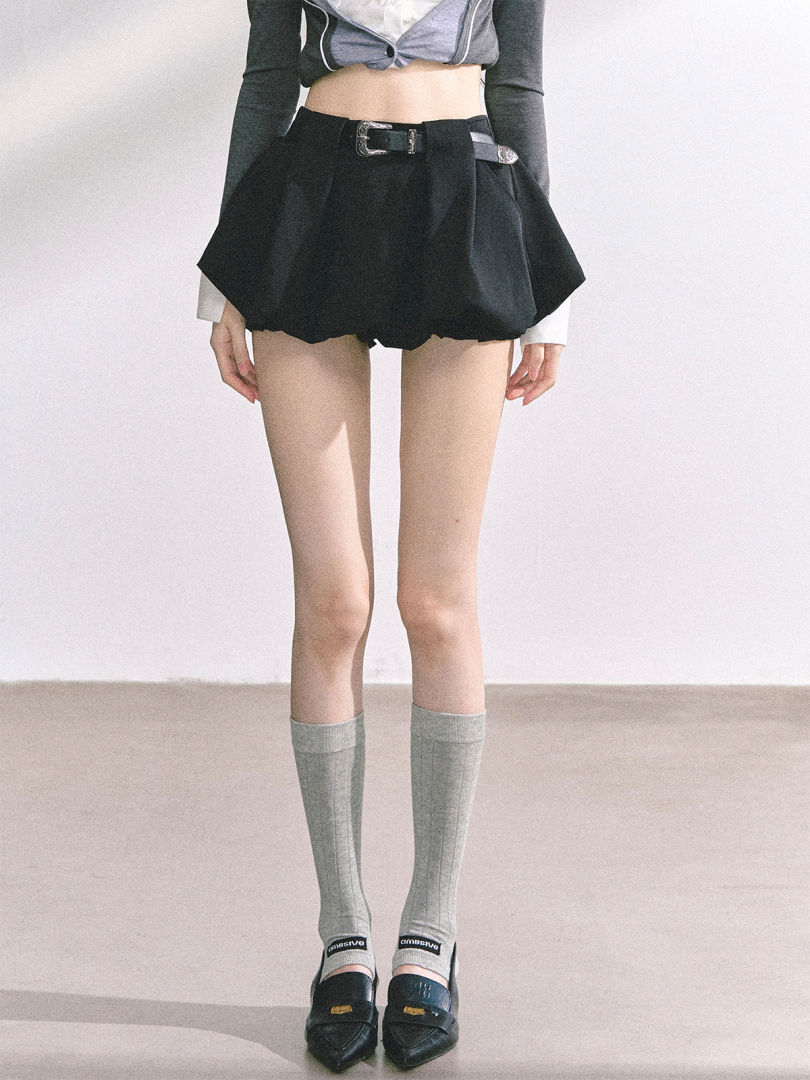 Black high-waisted belted shorts worn by a model