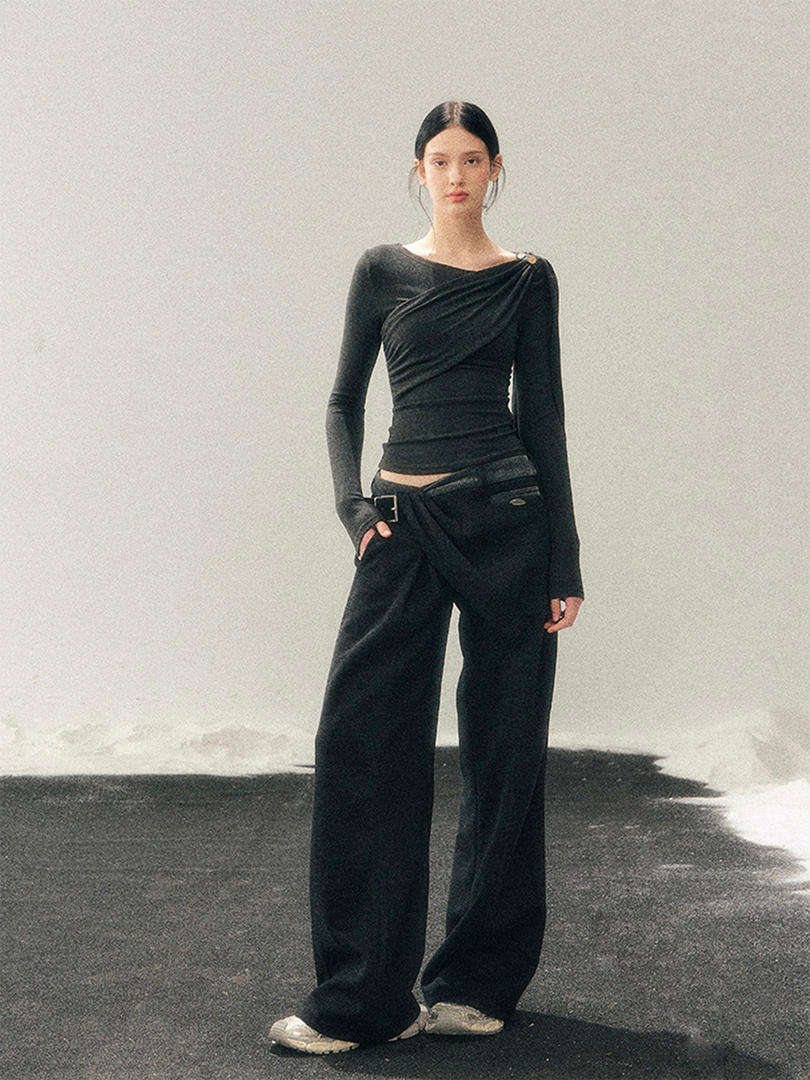 Model wearing a black long-sleeve fitted top with wide-leg black pants
