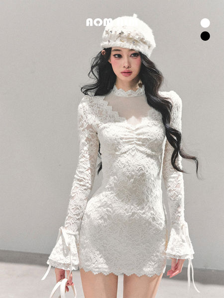White lace long-sleeve mini dress worn with a white fur hat