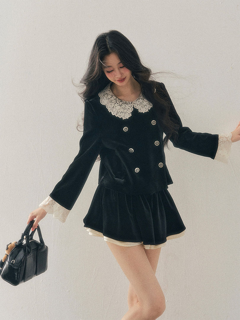 Black long-sleeve velvet dress with lace collar and cuffs worn by a model
