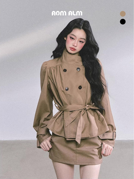 Model wearing a beige belted long-sleeve top and matching mini skirt set